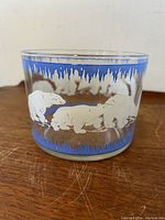 Front view of clear glass bowl with graphic of white polar bears and blue iced border.