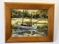 Frontal image of the oil painting on board featuring a moored sailboat by J. Lippert with wooden frame visible.
