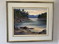 Framed oil landscape painting depicting Redstone Lake, Haliburton, signed by Pauline Holancin at lower right, with white mat and gold frame.