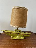 Front view of the yacht lamp showing chartreuse ceramic base and brown fabric lampshade