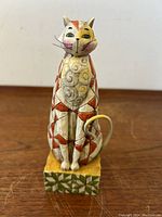 Front view of the vintage Jim Shore Heartwood Creek cat statue showing detailed painted geometric and swirl patterns.