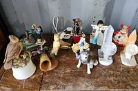 Overview of home decor and collectable items including animal figurines, horn ornaments, a music box, and bookends.