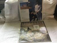 Front and back covers of two Cock Robin vinyl albums wrapped in plastic