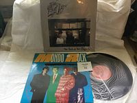 Photo showing front covers of Mondo Rock and The Rave Ups albums with the Mondo Rock vinyl record partially visible