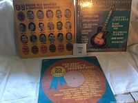 Front view of 3 vintage country and western music vinyl albums showing the album covers with titles and artist portraits.