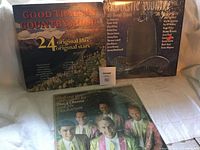 Front covers of three country music vinyl albums displayed on a white backdrop.