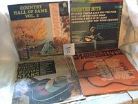 Four vintage country music vinyl album covers placed side by side, displaying titles and artwork.