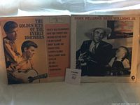 Front covers and spines of two country music vinyl records: The Everly Brothers and Hank Williams/Hank Williams Jr.