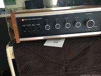 Front view of Electra solid state stereo amplifier showing control knobs, switches, and wooden side panels.