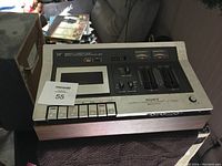 Front view of Sony stereo cassette recorder with control buttons and wood grain panel