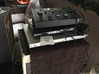 Stack of two DVD players, Sony on top of Toshiba, with stereo disco mixer on top, cables visible.