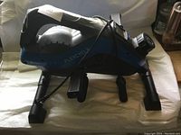 Blue and black FlexCycle under-desk bike showing side view with brand logo and structure.