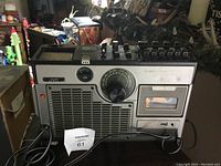 Front right angle view of the JVC radio cassette player stereo showing the tuning dial, speaker grill, cassette deck, control knobs, and handset.