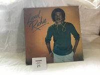 Front cover of Lionel Richie self-titled album showing autograph and album art with Lionel Richie in green sweater.