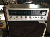 Front view of the Pioneer stereo receiver showing the tuning dial, control knobs, and power button