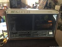 Front view of the Ampex Micro 87r stereo tape recorder showing control panel, input jacks, and tape mechanism window.