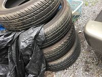 Four stacked Yokohama tires showing tread and size