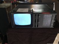 Full view of Sears VASHFX portable TV and radio unit showing small CRT display with power on and tuning section with radio frequencies visible.