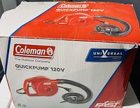 Photo of the Coleman QuickPump 120V box showing product image and branding with minor box damage.