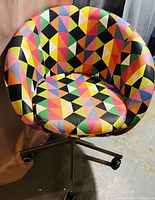 Full view of colorful geometric pattern stool by IKEA on casters.