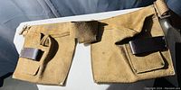 Photo of the whole tan leather tool belt showing pouches, loops, and belt strap