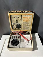 Micronta multitester model 22-204 analog multimeter with probes in original box, showing the tester, probes, and vintage box graphics.