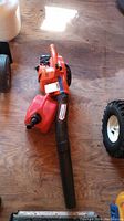 Full view of the orange Echo PB-250LN leaf blower with blower tube, fuel tank attached, and handle visible.