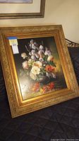 Full view of framed floral oil painting with price sticker on glass.