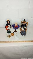 Full view of Halloween caroler figurines with table and accessories including small jack-o'-lantern, candle holder, and basket