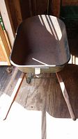 Front view inside the wheelbarrow showing the tub with rust spots.