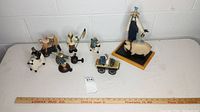 Lot overview of all seven Willi Raye Studio figurines arranged on a white surface showing complete set