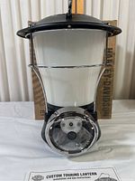Front and full view of the Harley Davidson Custom Touring Lantern showing black, white, and chrome details with instruction sheet visible.