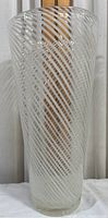 Front view of tall cylindrical clear glass vase with white spiraling stripes