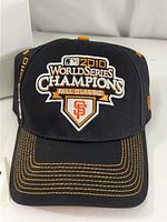 Front view of black MLB San Francisco Giants 2010 World Series Champions commemorative cap showing detailed embroidery on front panel.