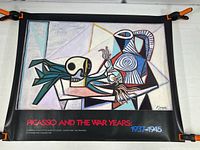Full view of the museum poster showing Picasso-inspired artwork with skull and jug. Exhibition title and dates at bottom in red and blue text.