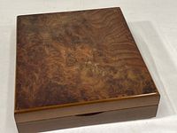 Top and side view of rectangular burl wood box showing detailed swirling grain pattern.