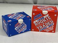 Two sealed boxes in original packaging - one blue and one red box both labeled 1988 Rookie & Traded Card Set from Score.