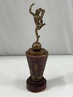 Front view of the vintage brass Mercury figurine standing on a globe atop a wooden base with the Maratha Light Infantry emblem. Shows overall condition and wear on wood.