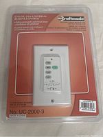 Front view of Craftmade UC-2000-3 universal ceiling fan remote control in packaging showing brand, model number, and included parts.