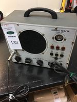 Front left-side view of Eico Signal Tracer showing speaker, handle, rotary knobs, cable, and connectors on front panel.