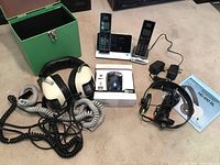 Lot with all items shown: Sennheiser headphones, Sansui headset, VTech cordless phones with accessories and manuals on floor.