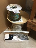 Partial spools of wiring and circuit breakers in box