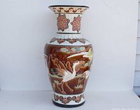 Front view of the large vintage Asian pottery vase showing the bird and floral majolica design.