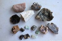 Top view of all rocks and minerals spread on white surface for size comparison