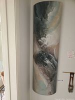 Photo of a vertical curved mixed media art piece signed E. Lee, showing the abstract textured and color details along its length.