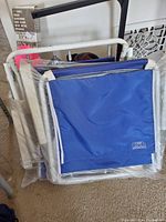 Blue Club folding chairs in folded position showing frames and fabric seats