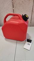 Front and side view of the red 10L fuel can with black cap and yellow spout cover, displaying capacity markings and handle.