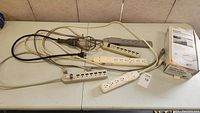 Photo showing five power strips and one wired trouble light on a table.
