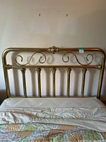 Full front view of the vintage brass bed frame installed on a bed with mattress and bedding, showing the overall design and size.
