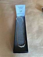 Full view of the necklace laid in presentation box